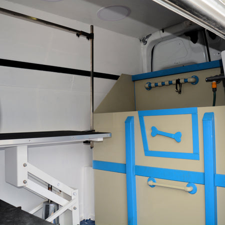 mobile dog bath unit inside grooming van with washing station