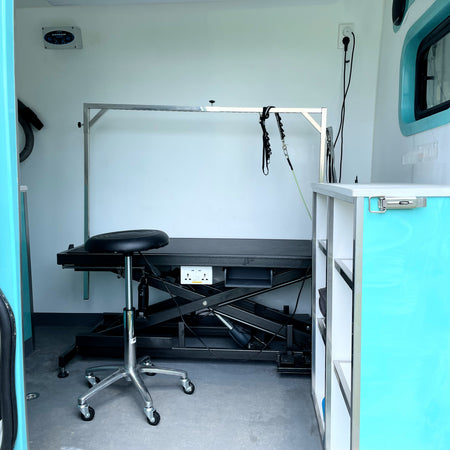 mobile dog grooming van with grooming table chair cabinet and dog leash