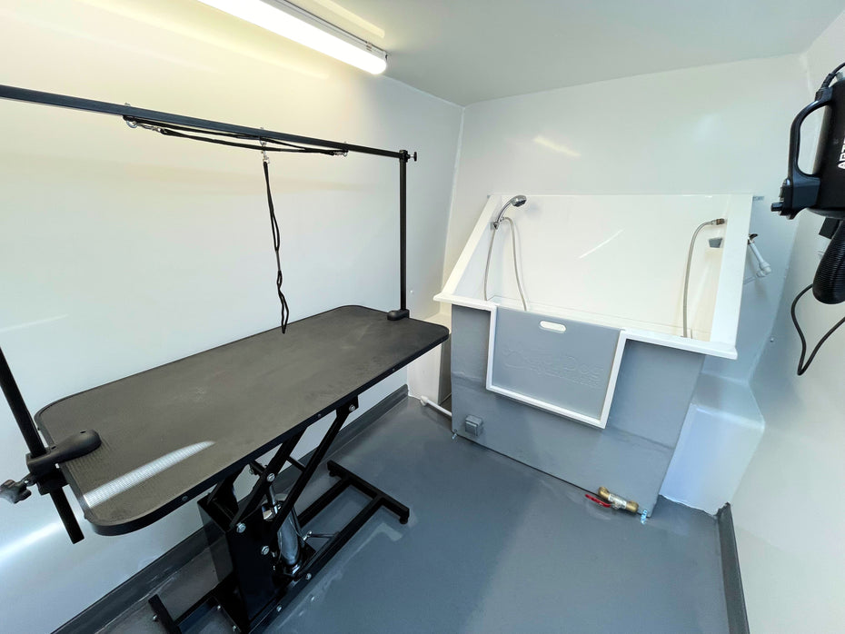 mobile dog grooming van interior with washable walls grooming table dog bath and hairdryer