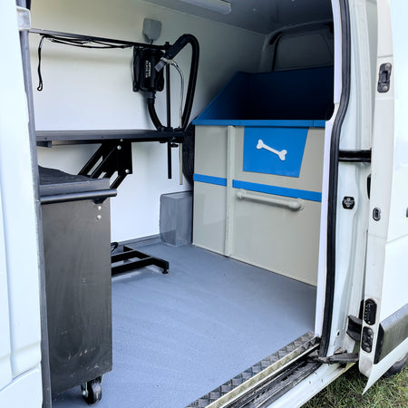 mobile dog grooming van interior with bath dryer and grooming table